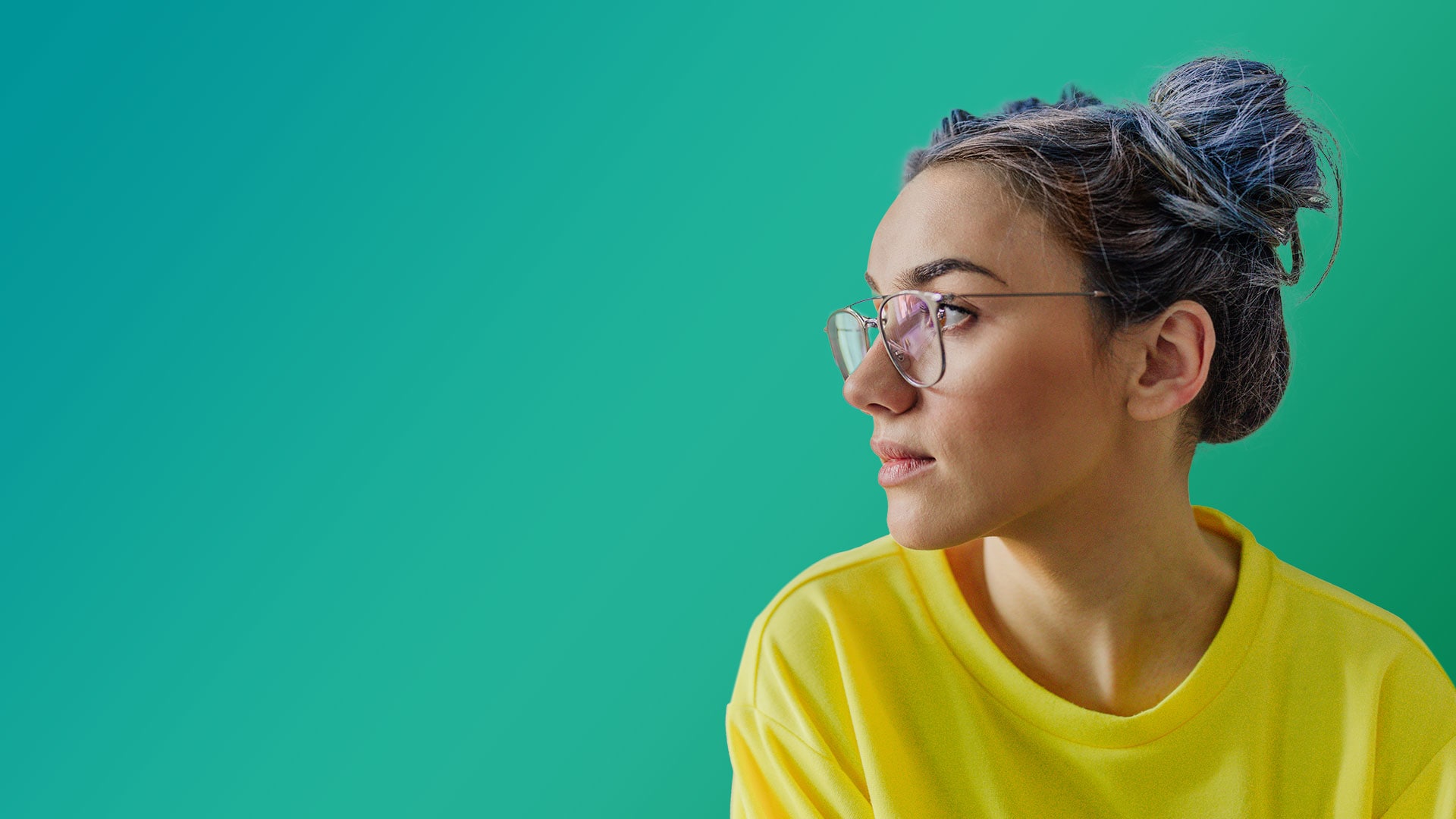 Image of a young woman with glasses, dyed hair and a yellow shirt looking to her right