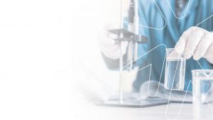 Background image showing closeup of a scientiste working on a lab with the outline of the Viridian logo overlay